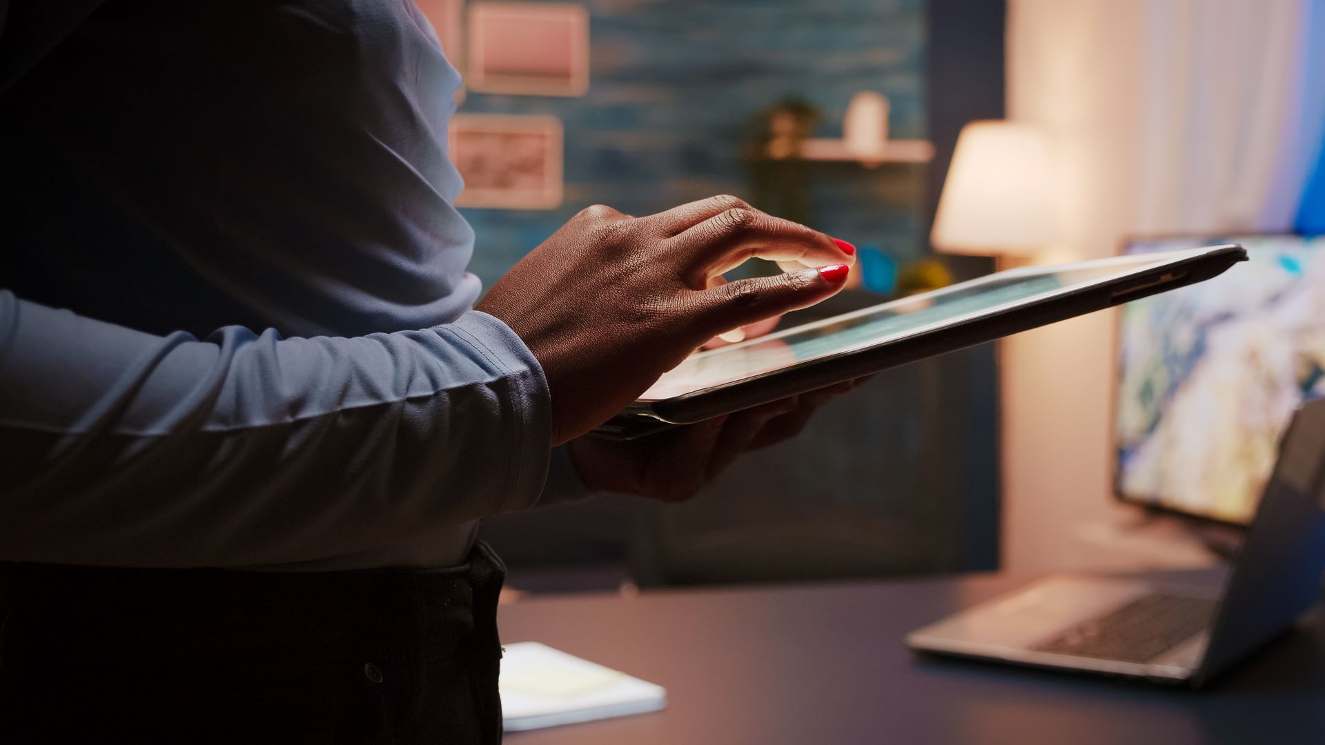 Corporate agency leader utilizing a digital tablet to manage online operations, automated marketing workflows, and growth scaling systems at a professional office workstation.