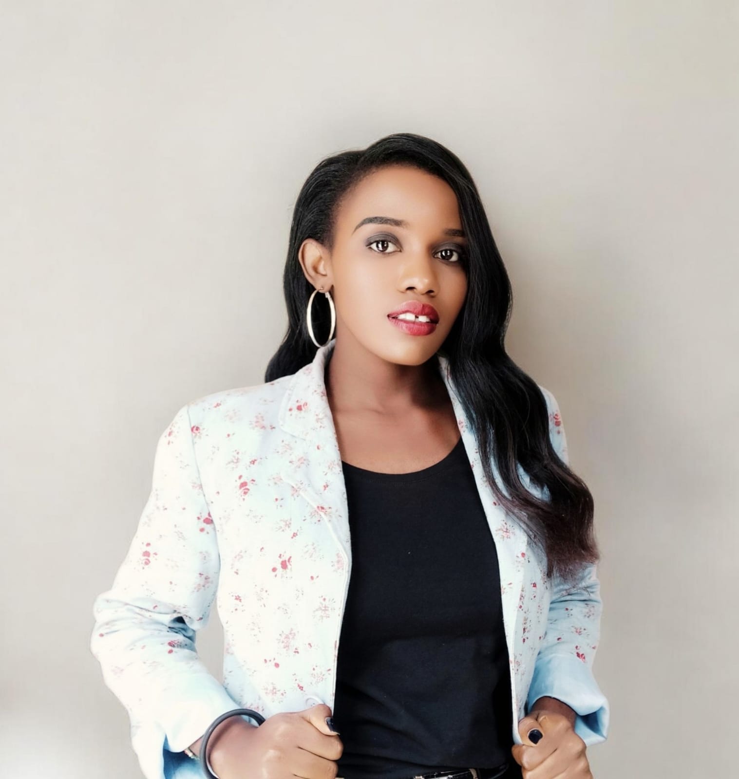 Professional portrait of Truphenah Liyala, Founder of Perfect Digital Marketing Solutions, wearing a light blue floral blazer and black top.